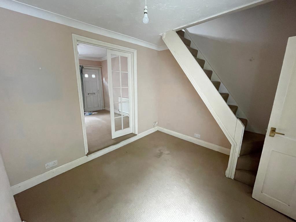 Lot: 126 - TERRACE HOUSE FOR IMPROVEMENT IN COLCHESTER CITY CENTRE - Dining room with french door to living room and stairs to first floor